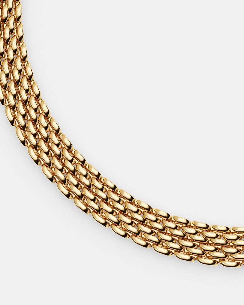 A polished stainless steel chain in 14k gold from Waldor & Co. One size. The model is Essence Chain Polished