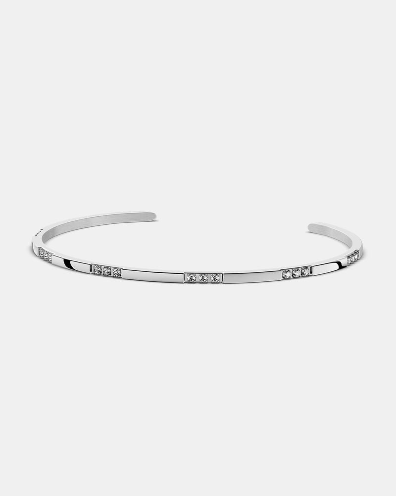 A Bangle in Rhodium-plated 316L stainless steel from Waldor & Co. One size. The model is Opulent Bangle Polished.
